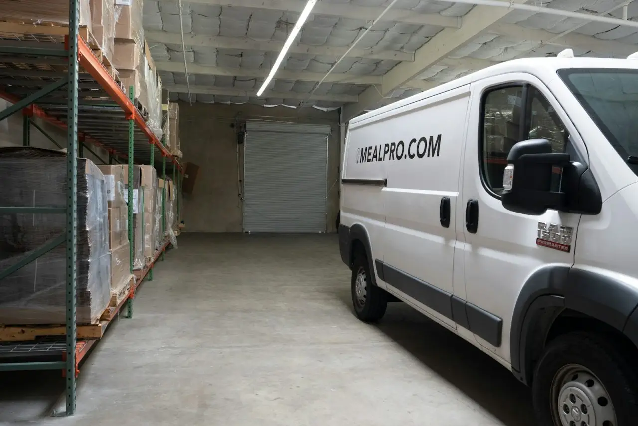 UAE e-invoicing for distributors: white delivery van parked in a distribution warehouse before its sales route